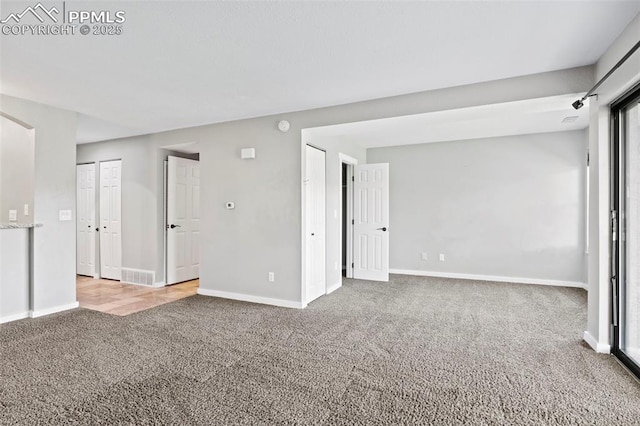 128 W Rockrimmon Blvd Unit 105, Colorado Springs, CO 80919 - carpeted empty room featuring baseboards and a smoke detector