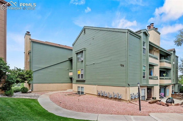 128 W Rockrimmon Blvd Unit 105, Colorado Springs, CO 80919 - view of home's exterior featuring a chimney