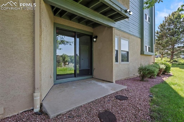 128 W Rockrimmon Blvd Unit 105, Colorado Springs, CO 80919 - doorway to property featuring stucco siding and a patio