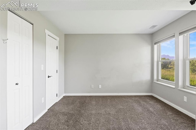 128 W Rockrimmon Blvd Unit 105, Colorado Springs, CO 80919 - unfurnished bedroom featuring carpet and baseboards