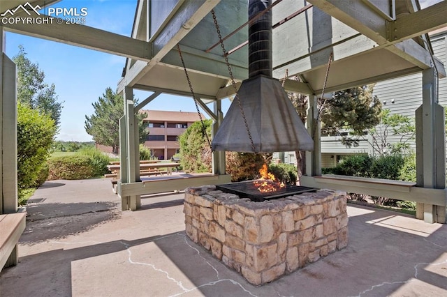 128 W Rockrimmon Blvd Unit 105, Colorado Springs, CO 80919 - view of patio / terrace featuring an outdoor fire pit