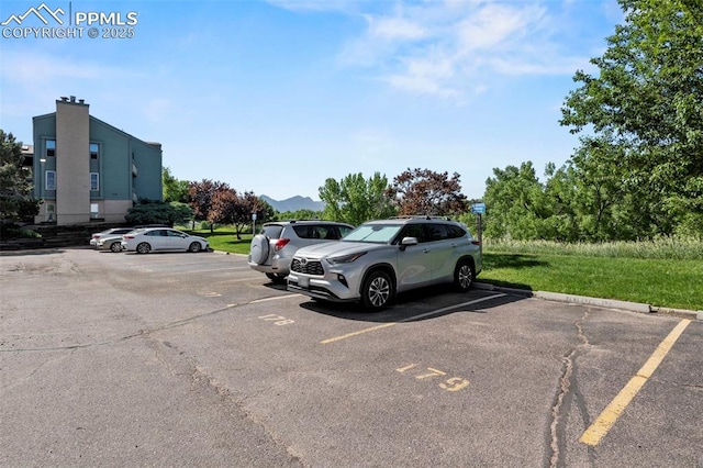 128 W Rockrimmon Blvd Unit 105, Colorado Springs, CO 80919 - uncovered parking lot featuring a mountain view