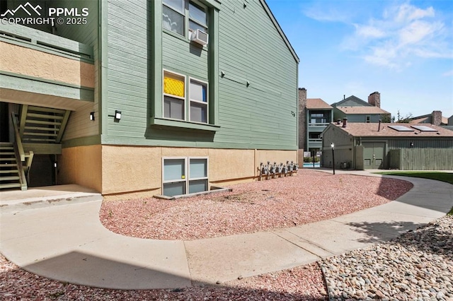 128 W Rockrimmon Blvd Unit 105, Colorado Springs, CO 80919 - view of side of home featuring stairway, a residential view, and cooling unit