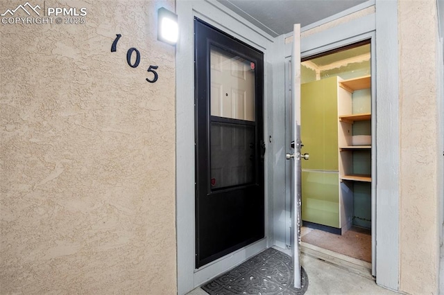 128 W Rockrimmon Blvd Unit 105, Colorado Springs, CO 80919 - doorway to property featuring stucco siding