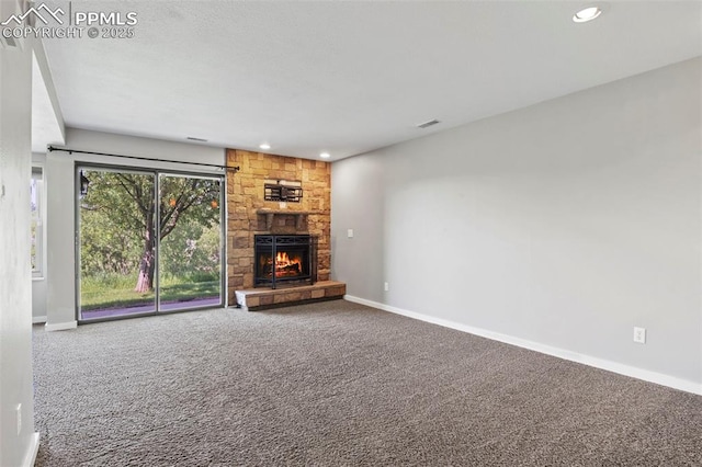 128 W Rockrimmon Blvd Unit 105, Colorado Springs, CO 80919 - unfurnished living room featuring carpet flooring, a stone fireplace, and recessed lighting