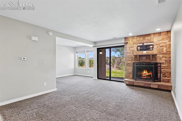 128 W Rockrimmon Blvd Unit 105, Colorado Springs, CO 80919 - unfurnished living room featuring carpet flooring, a fireplace, and recessed lighting