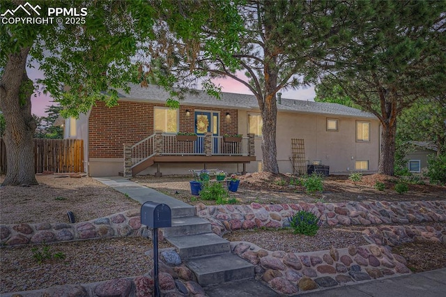 3660 E Wade Ln, Colorado Springs, CO 80917 - single story home featuring a porch, brick siding, and stairway