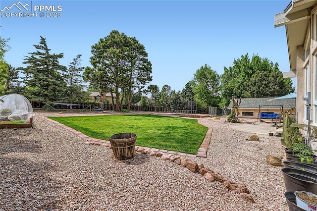 3660 E Wade Ln, Colorado Springs, CO 80917 - view of yard featuring a trampoline and a patio