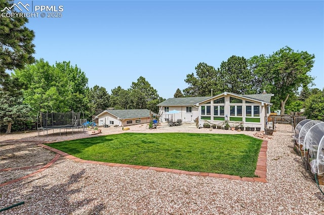 3660 E Wade Ln, Colorado Springs, CO 80917 - rear view of house with a trampoline, a patio area, and view of wooded area