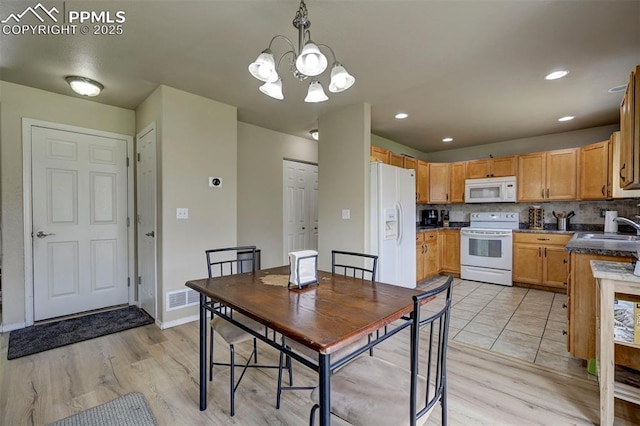4959 Gami Way, Colorado Springs, CO 80911 - dining space with light wood finished floors, a chandelier, baseboards, and recessed lighting