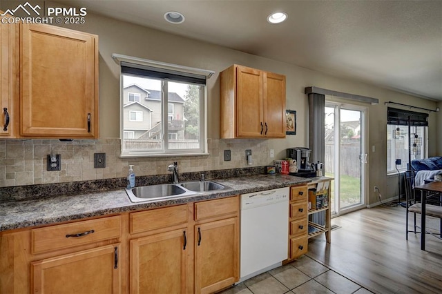 4959 Gami Way, Colorado Springs, CO 80911 - kitchen with white dishwasher, a sink, backsplash, dark countertops, and recessed lighting