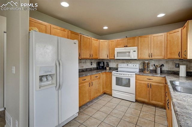 4959 Gami Way, Colorado Springs, CO 80911 - kitchen with white appliances, light tile patterned flooring, backsplash, a sink, and dark countertops