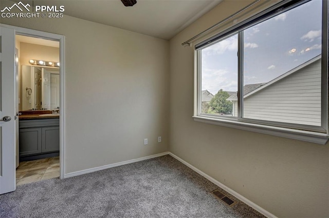 4959 Gami Way, Colorado Springs, CO 80911 - unfurnished bedroom with light colored carpet, a sink, baseboards, and ensuite bath