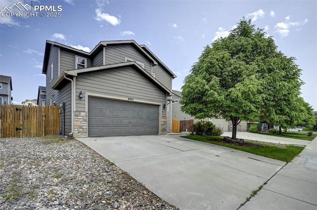 4959 Gami Way, Colorado Springs, CO 80911 - view of front of property featuring driveway, a garage, and stone siding