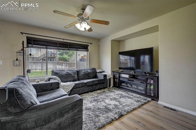 4959 Gami Way, Colorado Springs, CO 80911 - living room with wood finished floors, a ceiling fan, and baseboards
