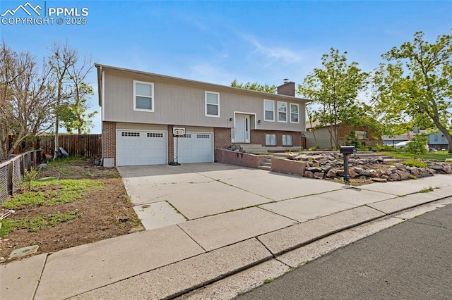 4623 Ranch Cir, Colorado Springs, CO 80918 - split foyer home featuring brick siding, a chimney, a garage, and driveway