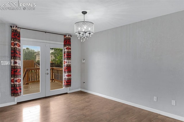4623 Ranch Cir, Colorado Springs, CO 80918 - unfurnished room with french doors, wood-type flooring, a chandelier, and baseboards