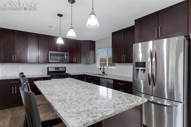 4623 Ranch Cir, Colorado Springs, CO 80918 - kitchen featuring stainless steel appliances, a sink, decorative backsplash, and a center island