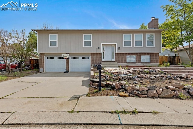 4623 Ranch Cir, Colorado Springs, CO 80918 - split foyer home featuring brick siding, an attached garage, concrete driveway, a chimney, and entry steps