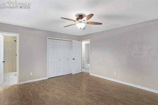 4623 Ranch Cir, Colorado Springs, CO 80918 - unfurnished bedroom featuring baseboards, wood finished floors, ensuite bathroom, a ceiling fan, and a closet