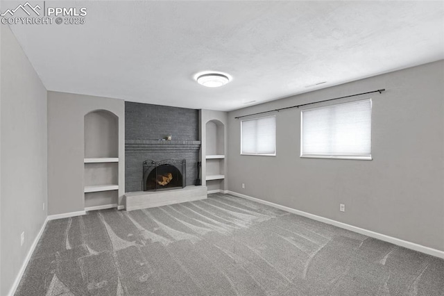 4623 Ranch Cir, Colorado Springs, CO 80918 - unfurnished living room with carpet, baseboards, a brick fireplace, and built in shelves