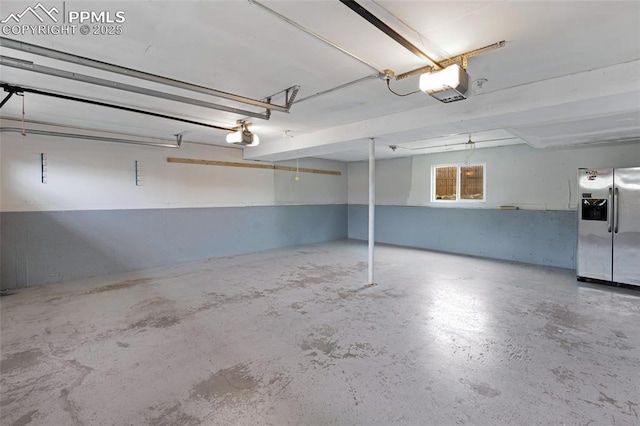 4623 Ranch Cir, Colorado Springs, CO 80918 - garage featuring stainless steel fridge and a garage door opener