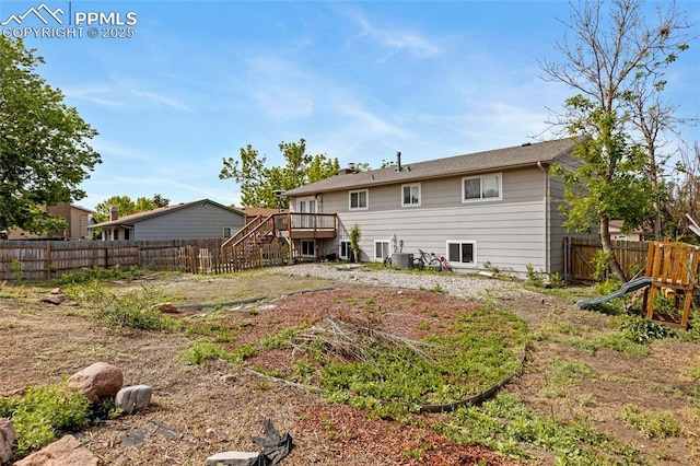 4623 Ranch Cir, Colorado Springs, CO 80918 - back of house featuring stairs, a fenced backyard, and a deck