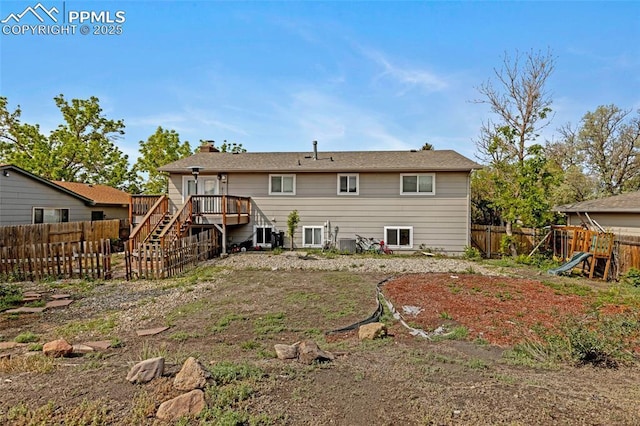4623 Ranch Cir, Colorado Springs, CO 80918 - back of house with stairway, a fenced backyard, a deck, a chimney, and cooling unit