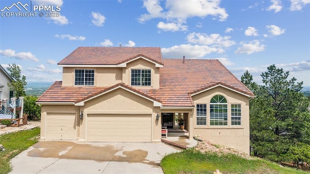 2915 Pegasus Dr, Colorado Springs, CO 80906 - traditional-style home with driveway, stucco siding, a garage, and a tile roof