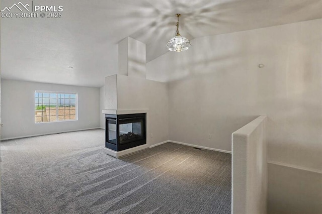 688 Bosque Vista Pt, Colorado Springs, CO 80916 - unfurnished living room featuring carpet, a multi sided fireplace, and baseboards