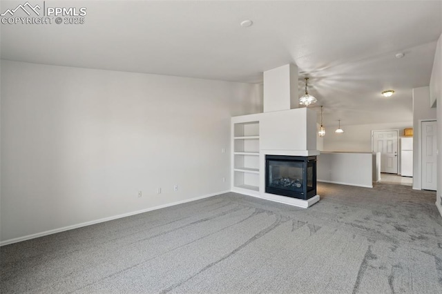 688 Bosque Vista Pt, Colorado Springs, CO 80916 - unfurnished living room with carpet flooring, baseboards, and a multi sided fireplace