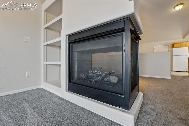 688 Bosque Vista Pt, Colorado Springs, CO 80916 - detailed view of freestanding refrigerator, carpet flooring, and baseboards