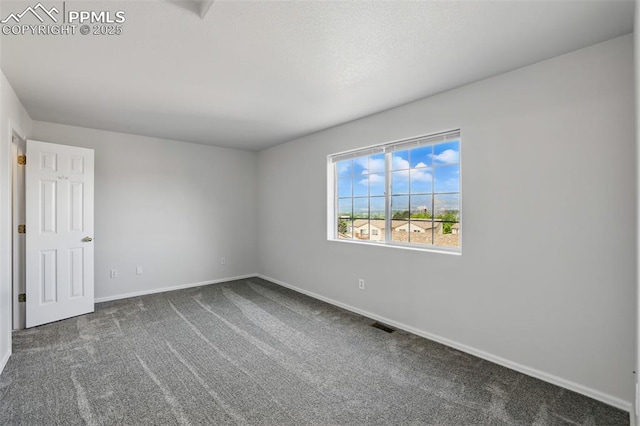 688 Bosque Vista Pt, Colorado Springs, CO 80916 - empty room featuring baseboards and dark colored carpet