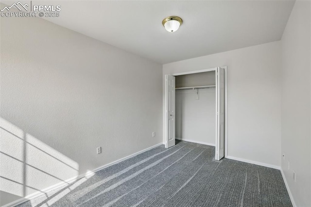 688 Bosque Vista Pt, Colorado Springs, CO 80916 - unfurnished bedroom with dark carpet, baseboards, and a closet