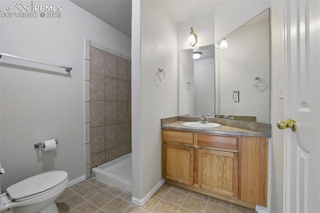 688 Bosque Vista Pt, Colorado Springs, CO 80916 - bathroom with vanity, toilet, tiled shower, baseboards, and tile patterned floors