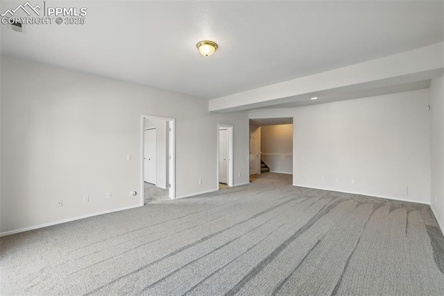688 Bosque Vista Pt, Colorado Springs, CO 80916 - spare room featuring light colored carpet, baseboards, and stairs