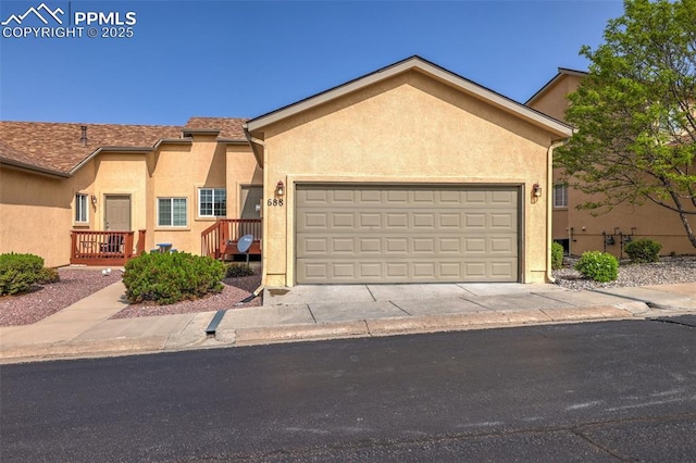 688 Bosque Vista Pt, Colorado Springs, CO 80916 - view of front of home featuring stucco siding, an attached garage, and concrete driveway