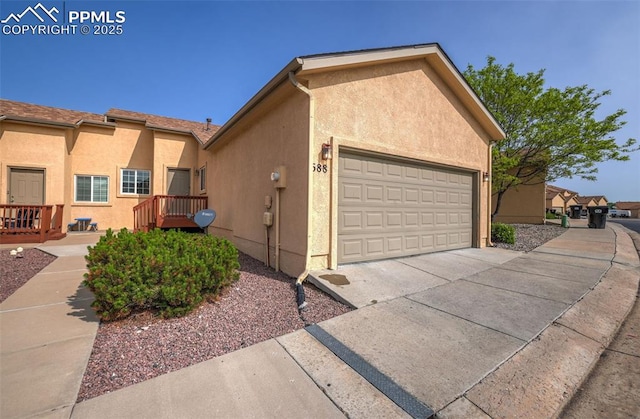 688 Bosque Vista Pt, Colorado Springs, CO 80916 - view of side of home featuring stucco siding and an attached garage