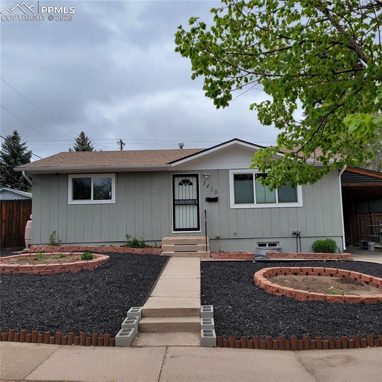 3410 E Bijou St, Colorado Springs, CO 80909 - ranch-style house featuring board and batten siding