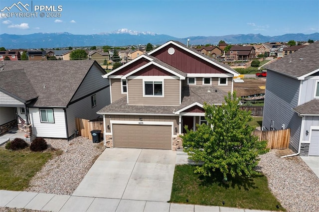 6078 Jorie Rd, Colorado Springs, CO 80927 - craftsman inspired home with board and batten siding, a mountain view, concrete driveway, and a residential view