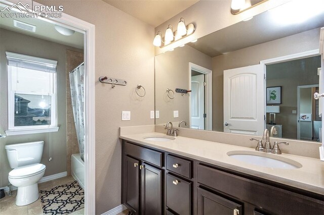 6078 Jorie Rd, Colorado Springs, CO 80927 - full bath featuring double vanity, toilet, shower / bath combination with curtain, tile patterned floors, and baseboards