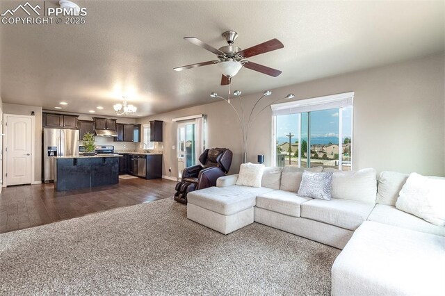 6078 Jorie Rd, Colorado Springs, CO 80927 - living room with a chandelier, ceiling fan, dark wood-type flooring, and recessed lighting