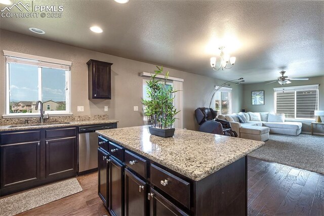 6078 Jorie Rd, Colorado Springs, CO 80927 - kitchen with stainless steel dishwasher, a sink, wood finished floors, a chandelier, and a textured ceiling