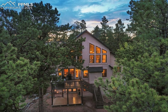 2100 N Elk Rdg, Divide, CO 80814 - rear view of house featuring a wooden deck, stairs, and stucco siding