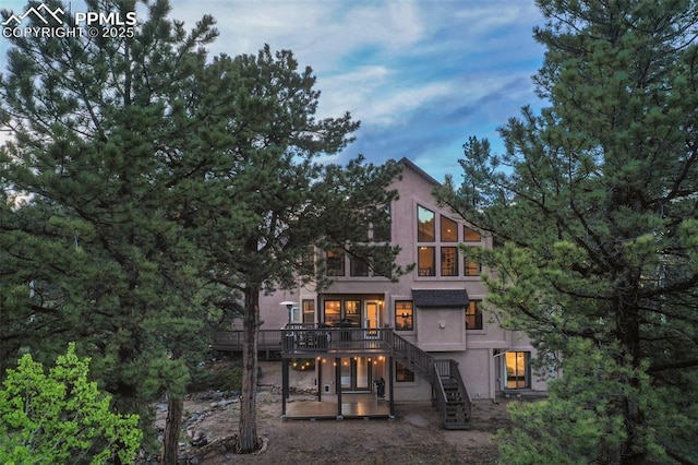 2100 N Elk Rdg, Divide, CO 80814 - rear view of house with stairs, a deck, stucco siding, and a patio area
