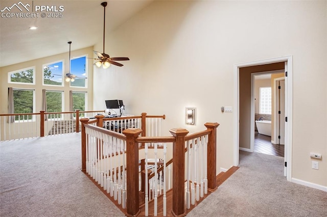 2100 N Elk Rdg, Divide, CO 80814 - hall with carpet flooring, an upstairs landing, baseboards, and high vaulted ceiling