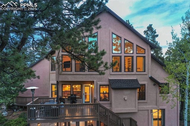 2100 N Elk Rdg, Divide, CO 80814 - rear view of property with stucco siding, stairs, and a wooden deck