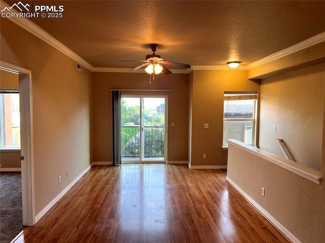 6967 Stetson Ranch Pt Unit 204, Colorado Springs, CO 80922 - unfurnished room featuring ceiling fan, wood finished floors, a textured ceiling, ornamental molding, and baseboards
