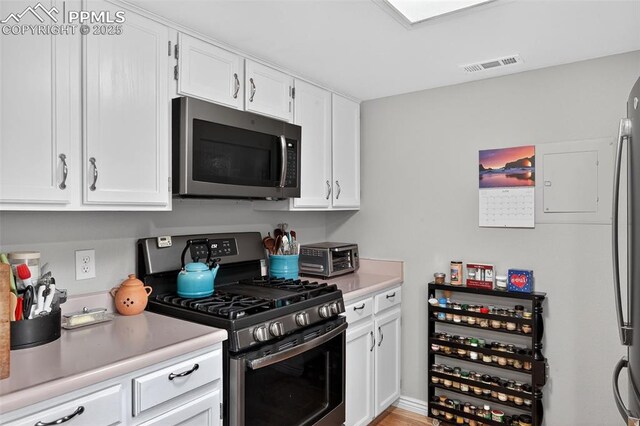 686 Echo Ln, Colorado Springs, CO 80904 - kitchen with stainless steel appliances, light countertops, and white cabinetry