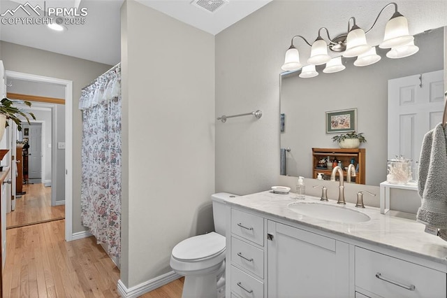686 Echo Ln, Colorado Springs, CO 80904 - bathroom featuring vanity, wood finished floors, and a shower with curtain